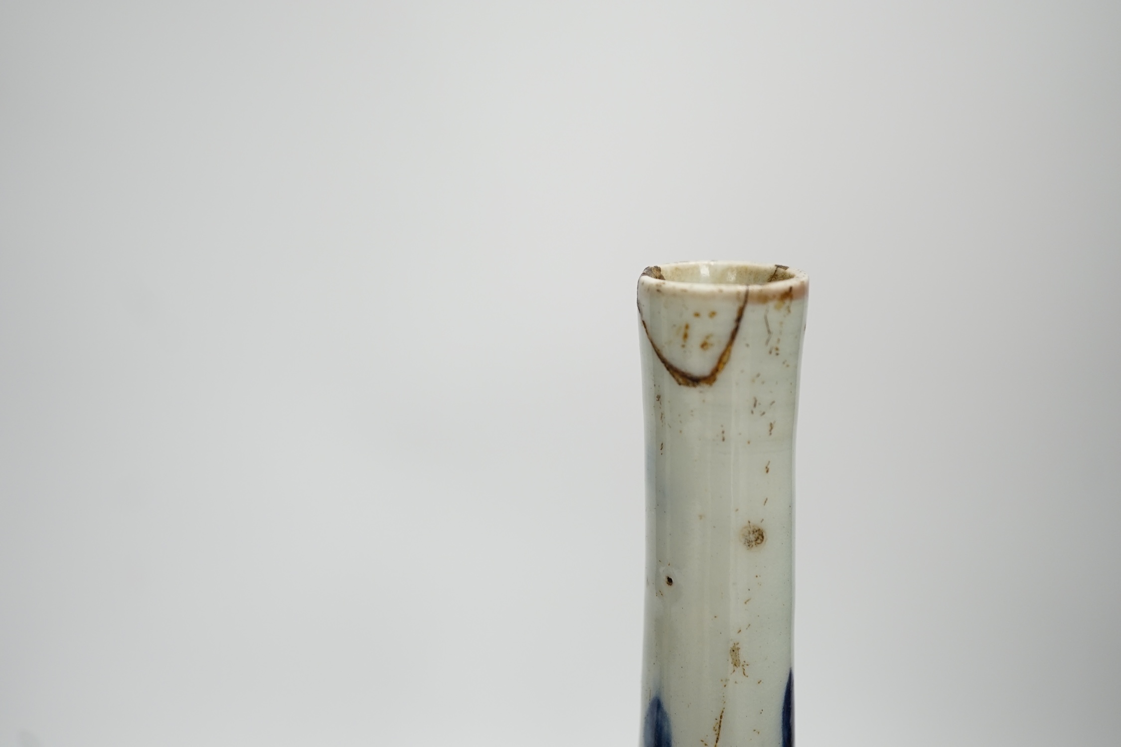 A pair of Japanese Arita bottle vases, c.1700, 24cm. Condition - heavily crazed, one with small section of neck broken and reglued